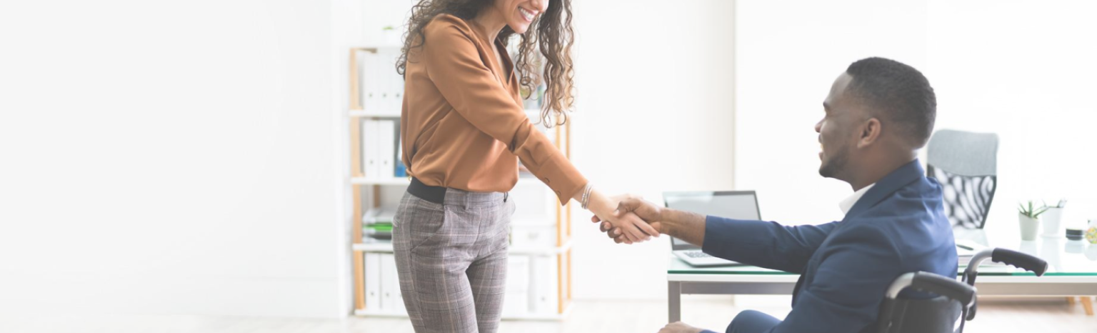 Two people in an office shaking hands